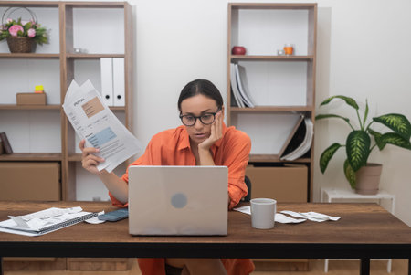 woman settles domestic bills online via a computer app, while a bank customer handles credit...