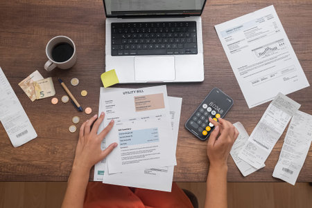 From above, a woman skillfully navigates financial planning, calculating household expenses, and...