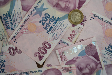 Close-up of Turkish lira banknotes and coins spread out. Concept of Turkish economy and inflation.