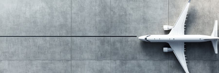 Sleek airplane waits on airport tarmac, ready for flight. White and modern, it gleams in the sun. Aerial view shows details against runway. Ideal for business and travel conceptsの素材