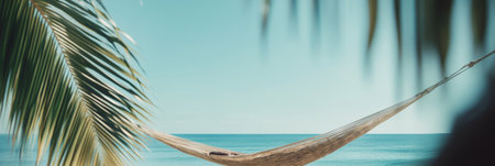 Empty hammock hanging between two palm trees on a tropical beach invites to relaxation and evokes a sense of peace and tranquility, perfect for summer vacationの素材