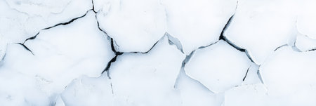 Dry, cracked earth creating intricate patterns under bright sunlight, emphasizing the profound effects of climate change and drought on the fragile environmentの素材