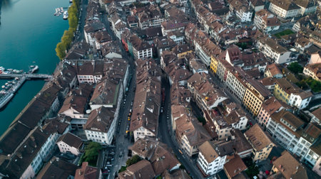 Capturing the charm of thun, switzerland, with its old town along the aare river, featuring traditional architecture, narrow streets, and a mix of modern and historic buildingsの素材