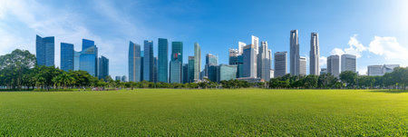Panoramic view capturing singapores stunning skyline, where modern skyscrapers rise above a lush green park, blending urban development with natural beauty under a clear blue skyの素材