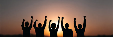 Silhouetted crowd raising fists at sunset, protesting immigration raids and civil unrest in the united states, symbolizing strength, unity, and resistance against government policiesの素材