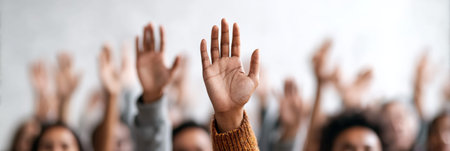 People participating in a protest, raising their hands together to symbolize unity and demand social justice, equality, and an end to immigration raids by ice in the usaの素材