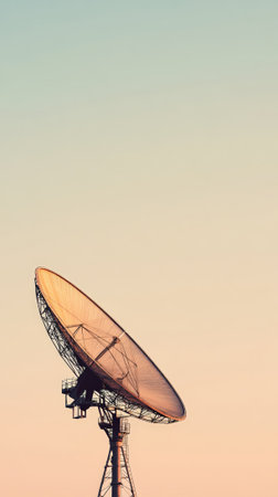 Large satellite dish pointing towards the sky at sunset, searching for signals from outer space, exploring the universe for signs of extraterrestrial life and gathering data from distant galaxiesの素材