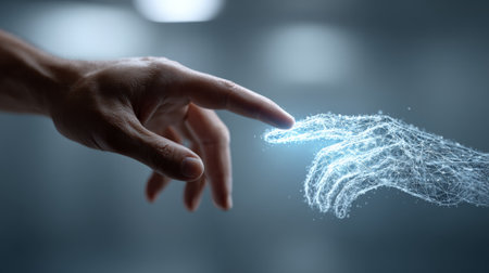 Human hand touching robotic hand, signaling emerging connection between human intelligence and digital technology, representing collaborative future of technological interactionの素材