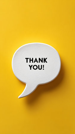White speech bubble reading thank you centered on a vibrant yellow background, minimalist graphic conveying gratitude, appreciation and positive feedback with clean copy spaceの素材