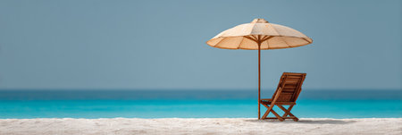 Tranquil beach setting featuring a solitary wooden chair and umbrella on pristine white sand, overlooking calm turquoise waters under a clear blue sky. Perfect for relaxation and leisureの素材