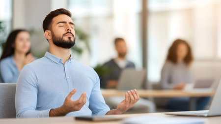 Office worker practicing mindfulness meditation at his desk, relieving stress and improving time management skills in a busy work environmentの素材