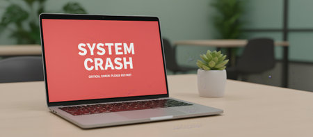 Laptop screen showing a system crash critical error message, indicating technical issues and computer malfunction on a minimalist wooden desk in a modern office environmentの素材