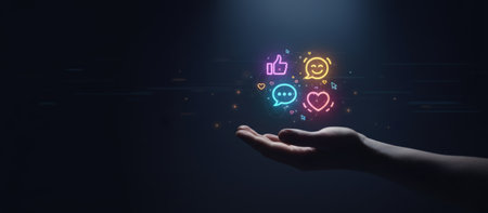 Hand holding glowing neon social media reaction icons like thumbs up, heart, chat bubble, and smiling emoji, representing digital communication and online engagement in a dark environmentの素材