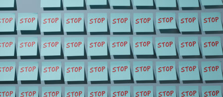 Repeating pattern of blue sticky notes with the word stop written in red on a gray wall, symbolizing warnings, restrictions, and an urgent call to haltの素材
