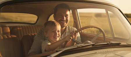 Happy father and cheerful son bonding and learning to drive an old automobile together, smiling and steering the wheel during a beautiful summer evening drive on a rural roadの素材