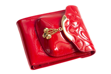 Red glossy leather purse with gold metal  isolated on whiteの写真素材