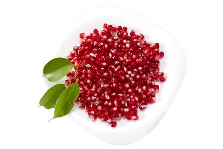 Pomegranate seed pile and green leavesの写真素材