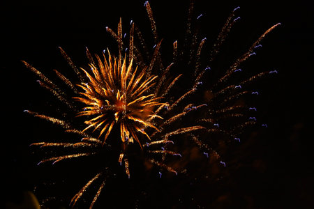 Golden orange amazing fireworks isolated on a dark background close-up