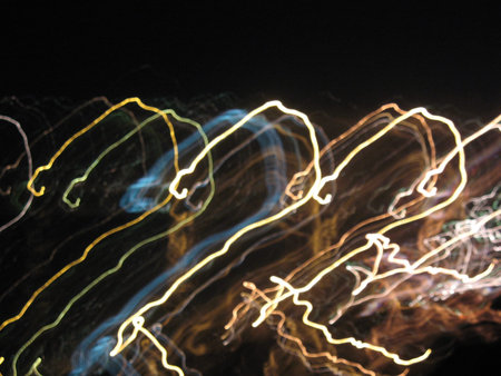 Abstract neon background, movement, multicolored highlights on a black background. High quality...