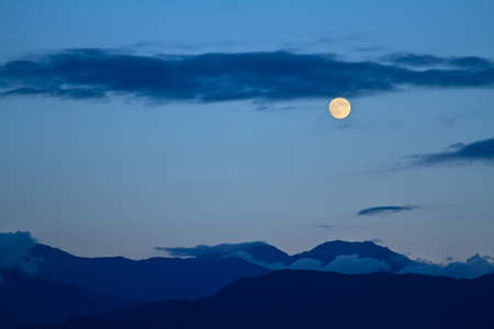 Full moon over mountains, Japan Alps の写真素材