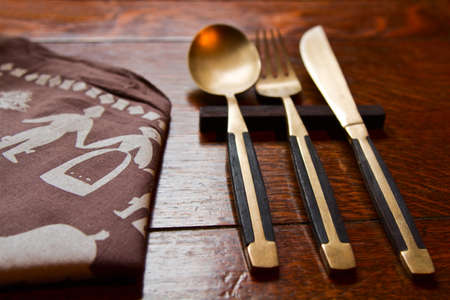 Old cutlery on wooden table.の写真素材