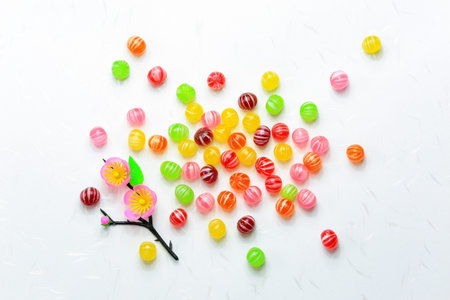 Colorful confectionery for Dolls' Festival (Hinamatsuri) on white Japanese paper background.