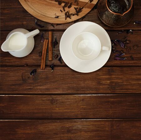 cup, milk and turk fresh coffee with cinnamon on a dark wooden table backgroundの写真素材