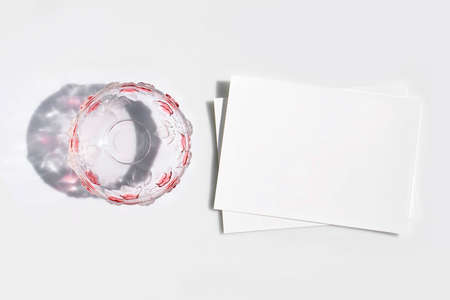 Mockup poster or flyer for presentation, white sheets of paper and glass vase with shadow on a gray background in a elegant modern minimalist style. Congratulations blank, stationery, business cardの写真素材