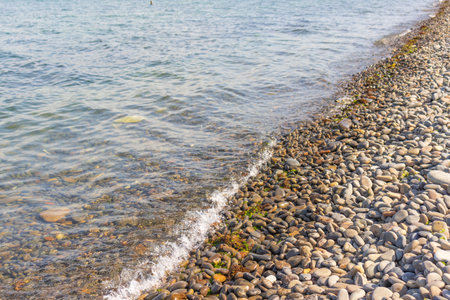 Sea stones in the sea water. Pebbles under water. The view from the top. Nautical background. clean seawater. transparent sea.の写真素材