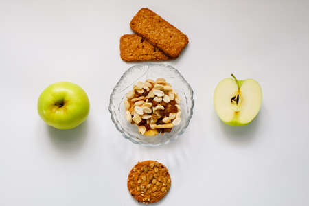 Healthy snack. Apples, nuts, oatmeal cookies on a white background.の写真素材
