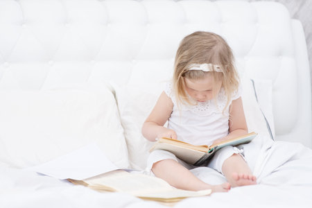 Homeschooling. Kids learning from home. Remote school, online education for young children during quarantine. Kid with laptop and tablet computer. Little girl study.の写真素材