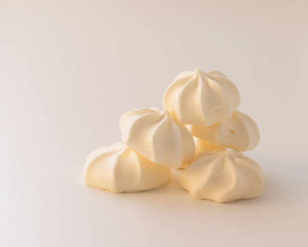 a bunch of cream meringues on a light backgroundの写真素材