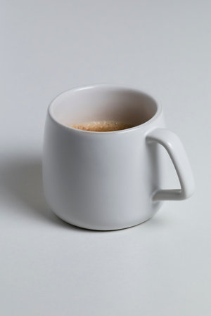 a white cup with coffee on white backgroundの写真素材