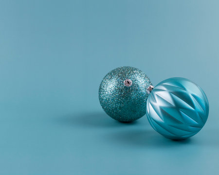 light blue turquoise christmas background and christmas ornaments. monochrome