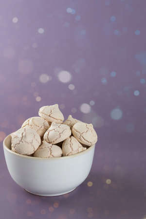 meringues in a bowl on a purple backgroundの写真素材