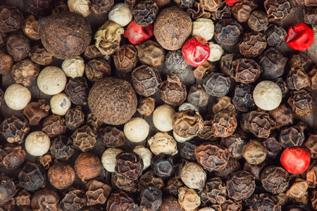 Peppers hot, red, black, white and gray grains as background. Close up.