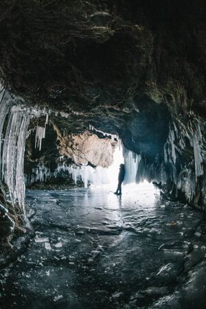 Man in an ice cave on Baikalの写真素材