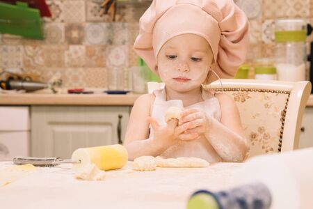 Little girl cooks at home in the kitchenの写真素材