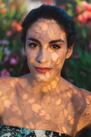 Girl in a dress posing in motion on a street backgroundの写真素材