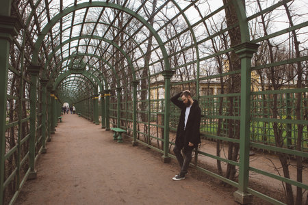 Man in the mantle in a city parkの写真素材