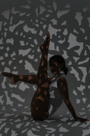 Girl dancer doing stretching in the studio