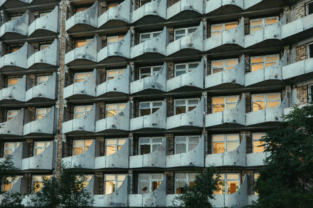 Old dirty broken ruined abandoned building, the ruins of the facade of a luxury hotel illuminated by sunlight.の写真素材