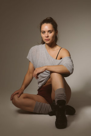 Sexy athletic girl in a fashion photo shoot takes gymnastic poses