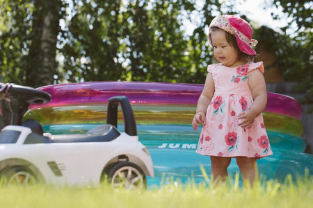 Little girl playing on the playground in the yardの写真素材