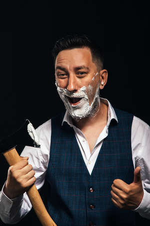 man shaving with axの写真素材