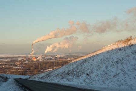 Power plant with smoke and dirty orange airの写真素材