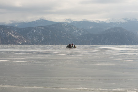 View of beautiful drawings on ice from cracks and bubbles of deep gas on the surface of lake Teletskoye , Russiaの写真素材