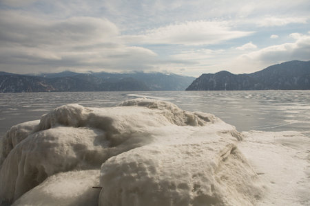 View of beautiful drawings on ice from cracks and bubbles of deep gas on the surface of lake...
