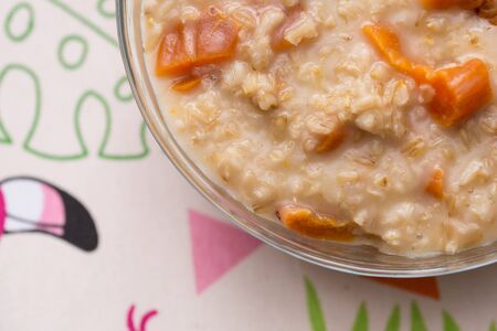 Sweet oatmeal porridge with dried apricotsの写真素材