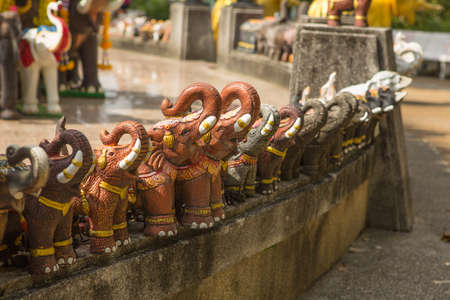 A close-up shot of elephant figurines in an outdoor park.の写真素材